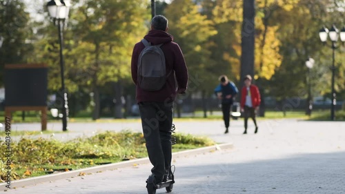 The guy rides an electric scooter on his own business, modern mode of transport