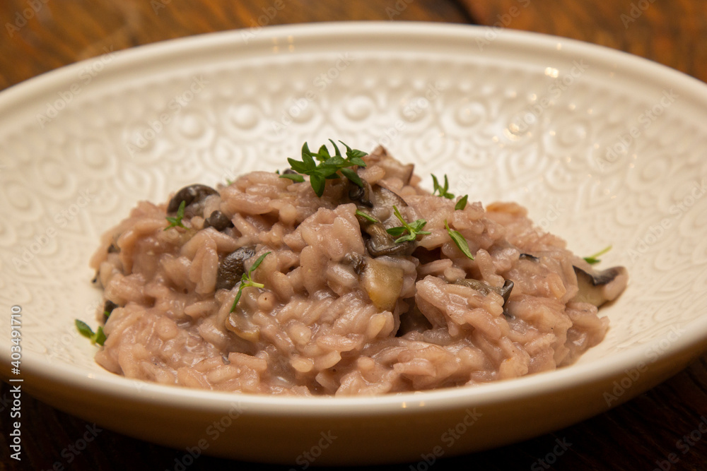 Mushroom risotto, on the wooden table. Mushroom risotto, on the wooden table.