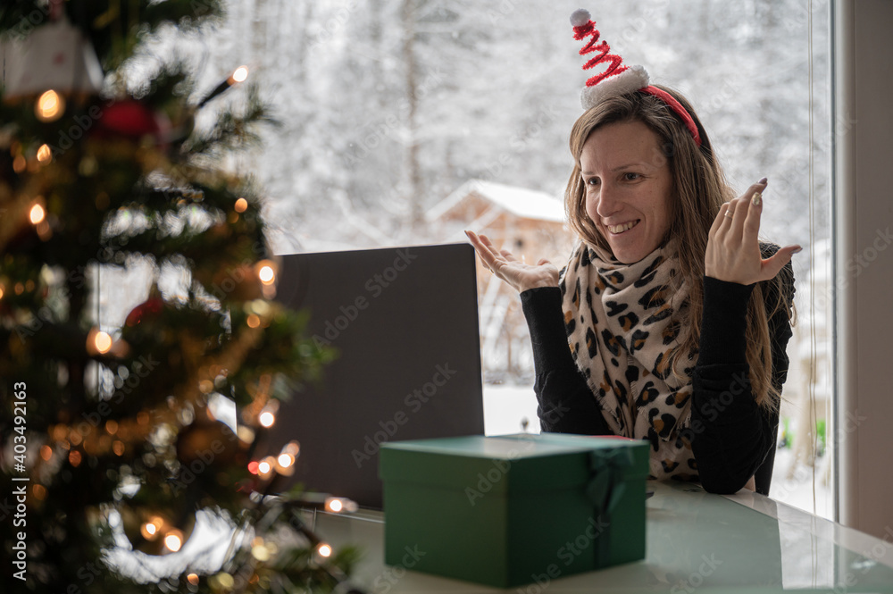 Young woman meeting her friends or family for holidays via computer Young woman meeting her friends or family for holidays via computer