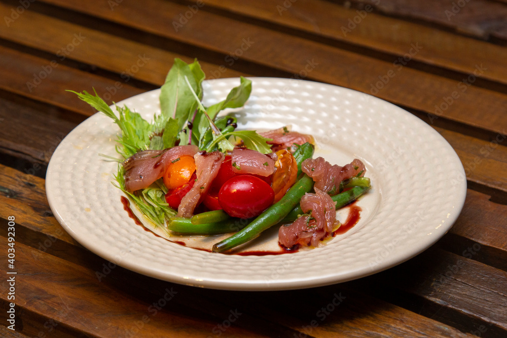 Nicoise salad - salad made with arugula, chopped tomatoes and anchovies. Nicoise salad - salad made with arugula, chopped tomatoes and anchovies.