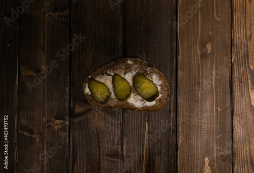 sandwich with lard and pickled cucumber on wooden table