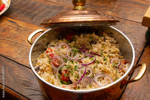 Cod rice and vegetables in the pan.