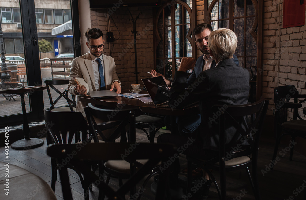 Fototapeta premium Business people holding a meeting at office cafeteria discussing about business plan.