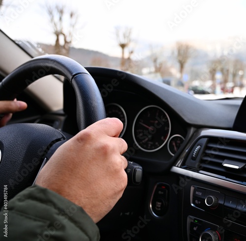 Man driving car. Hands on the steering wheel. 