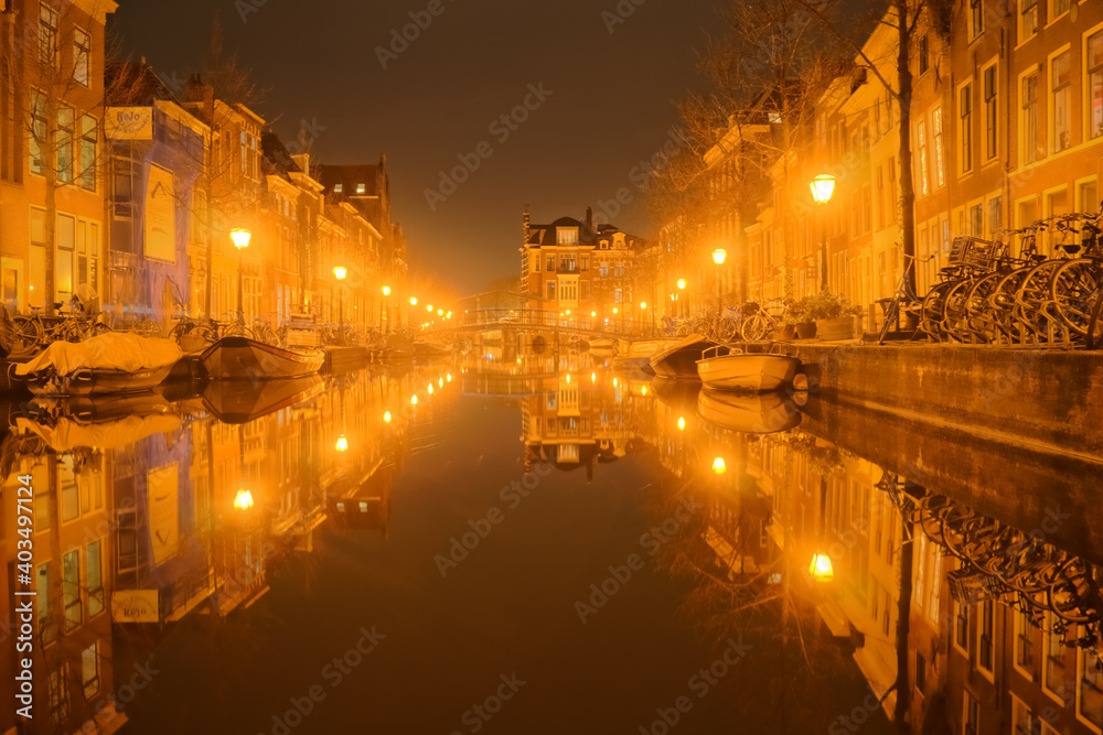Night in the foggy canal