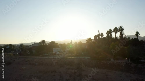 Small village in the desert at sunset, aerial view
drone view Palm trees Mountains and red rofftops,vered yericho, Israel
 photo