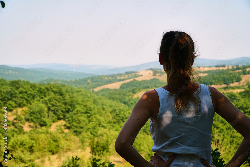 Human and nature. Look at trees from the mountain on a hike. Unity with the forest. High quality photo