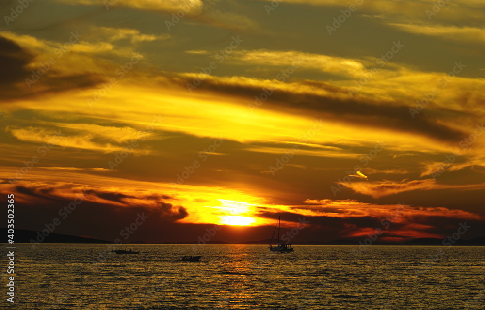 Vibrant golden, yellow an brown colors at sea sunset