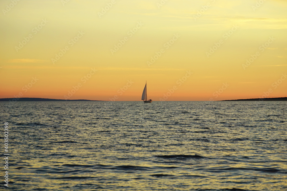 Vintage scene of yacht on the ocean at sunset