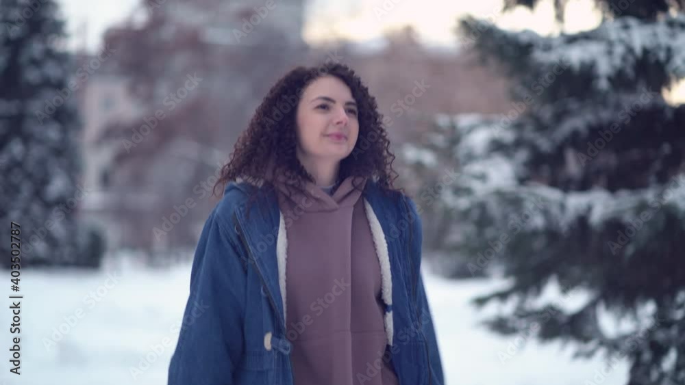 Happy young woman with afro curls in a winter city. Happy young woman with afro curls in a winter city.
