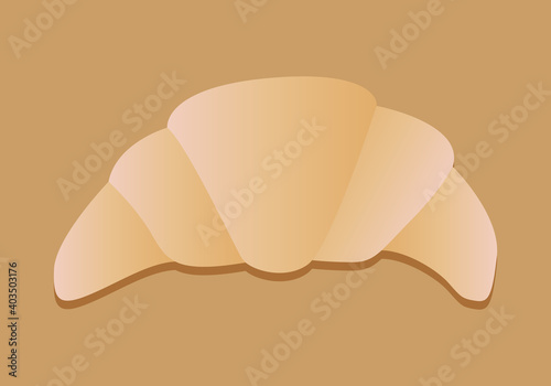 Un croissant en una mesa de madera.