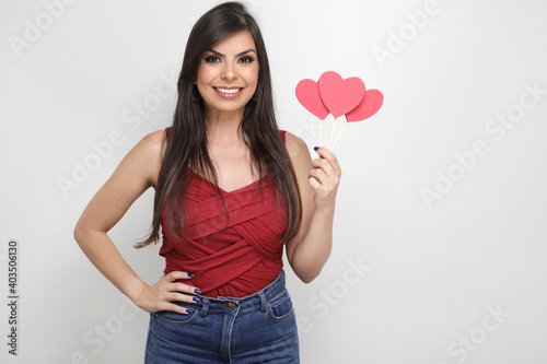 beautiful girl holding valentine's gift on white background © CassianoCorreia