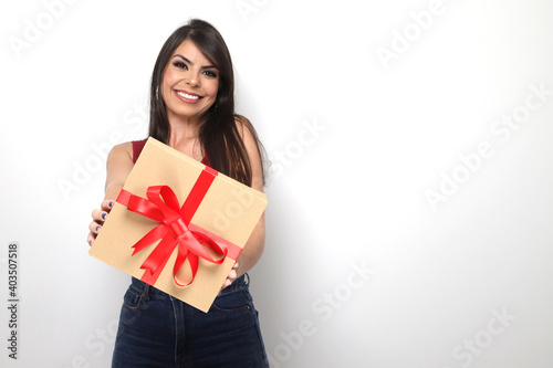 beautiful girl holding valentine's gift on white background