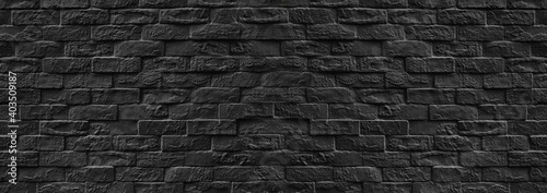 Surface of Vintage black brick wall background.