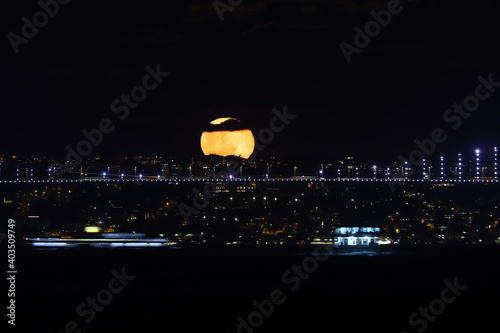 Full Moon rise over Bosphorus Bridge  Istanbul  Turkey