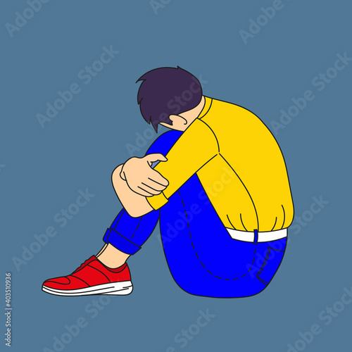 Sad guy sitting put his head on his knees.