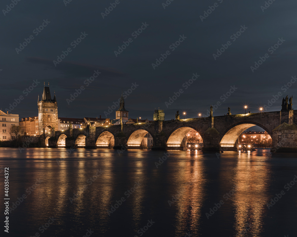 
Charles Bridge and light from street lights in Prague and the level of the Vltava River after sunset in the Czech Republic