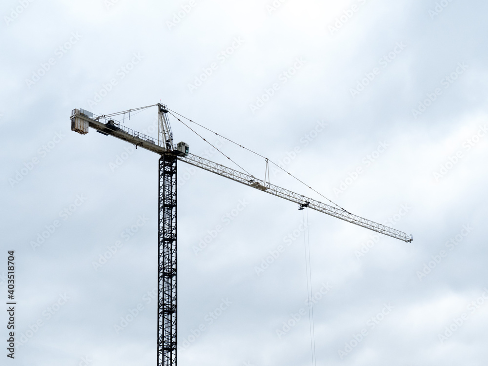 silhouette of a construction crane against a cloudy sky on a high rise building site silhouette of a construction crane against a cloudy sky on a high rise building site