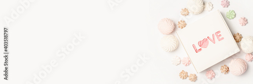 Gift box and sweets on a light background. Composition Valentine's Day. Banner. Flat lay, top view