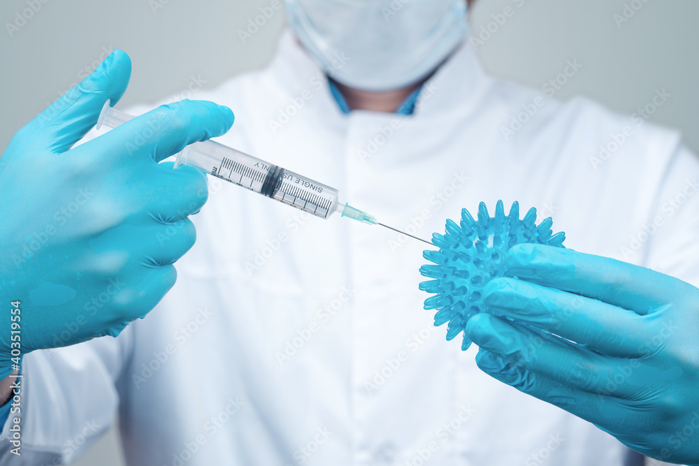 Doctor holding a syringe with vaccine against corona virus.