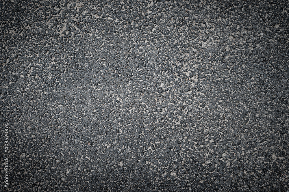 Asphalt road texture, top view. Dark grey abstract background.