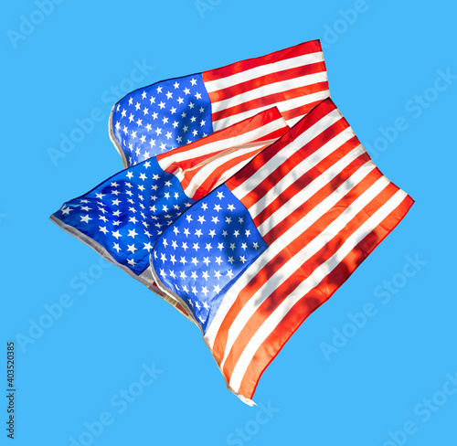 The group of the national flag of the United States of America on a blue sky background.