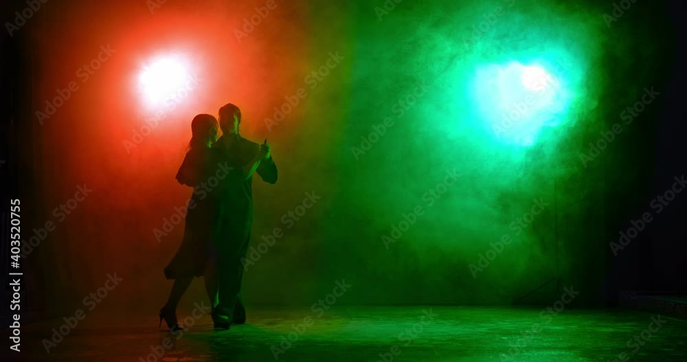 Silhouette, professional dancers in a dark dance hall with smoke and contrasting light, passionate tango. Beautiful dance poses, partners spin in the dance. 4k, ProRes Silhouette, professional dancers in a dark dance hall with smoke and contrasting light, passionate tango. Beautiful dance poses, partners spin in the dance. 4k, ProRes