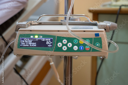 фотографія The automatic infusion device working beside the bed at hospital.