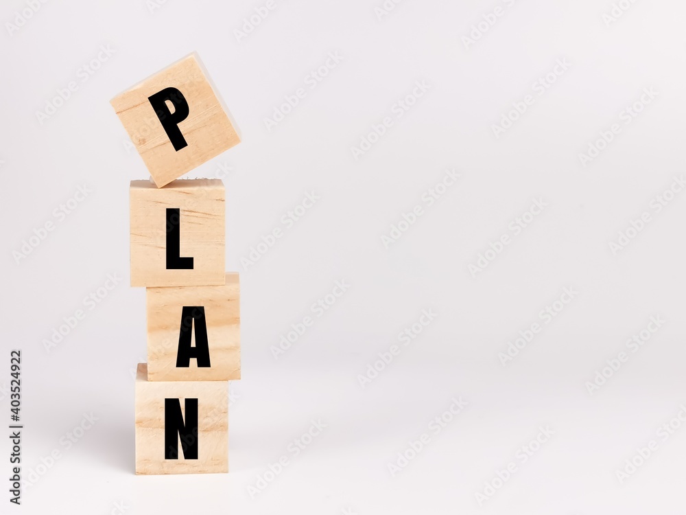 Phrase PLAN on wooden cubes isolated on white background.Business concept. Phrase PLAN on wooden cubes isolated on white background.Business concept.