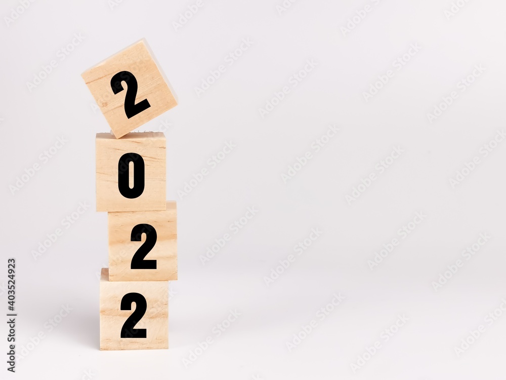 Text 2022 on wooden cubes isolated on white background.Business concept. Text 2022 on wooden cubes isolated on white background.Business concept.