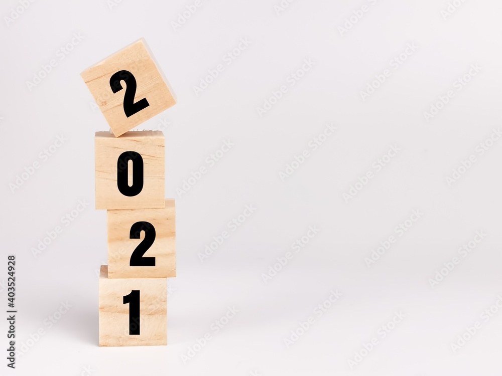 Text 2021 on wooden cubes isolated on white background.Business concept. Text 2021 on wooden cubes isolated on white background.Business concept.