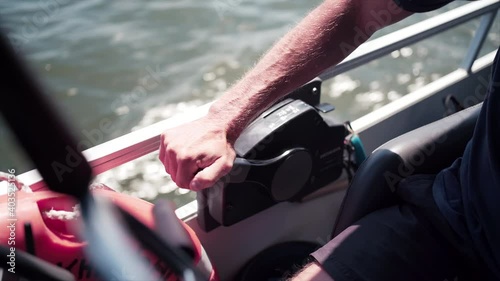 Man Adjusting Power Controls On Powerful Boat