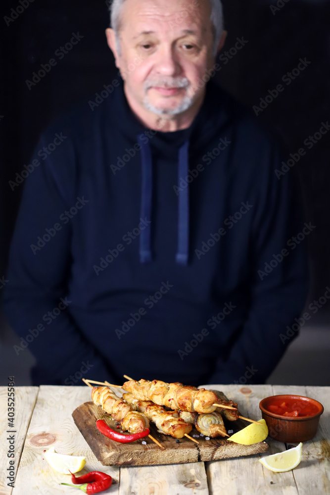 The gray-haired man prays before eating. Thanksgiving for the food. The gray-haired man prays before eating. Thanksgiving for the food.