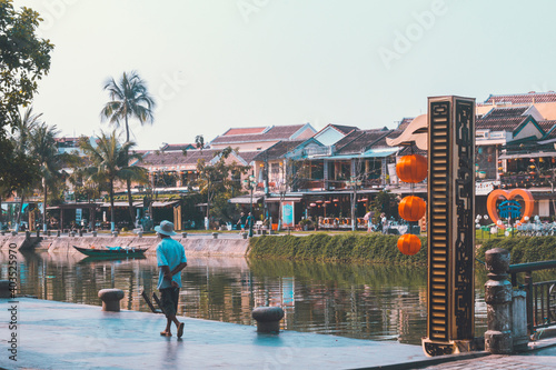 Hoi An, Vietnam - 09-04-2018: Colorful view of busy street and crowded river in Hoi An, Vietnam, famous for mixed cultures and architecture. Traditional colorful lanterns spread light all around.