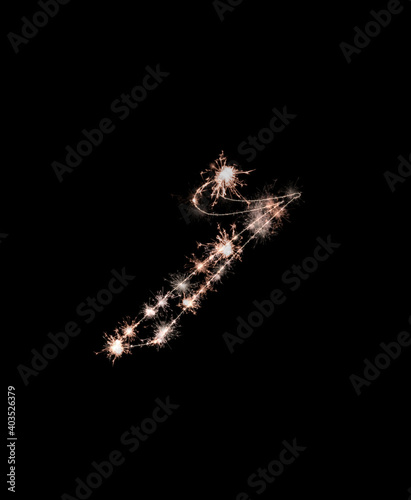 the digit 7 made from sparks of Bengal lights isolated on a black background.