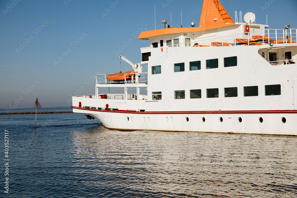 White passenger ship sails to an island in the North Sea