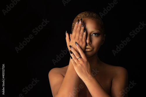 woman with golden makeup in set with nails manicure, eyebrows, hair