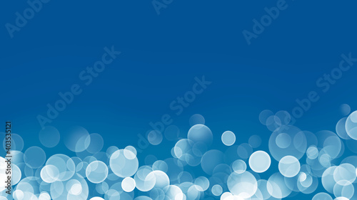 白色の玉ぼけと青色の抽象的な背景イメージ素材
