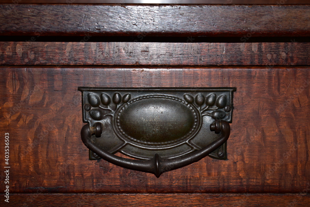close up of drawer pull on old Australian cabinet made of silky oak timber, Art Nouveau style