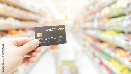 Credit card in hand shopping in malls with blurred background