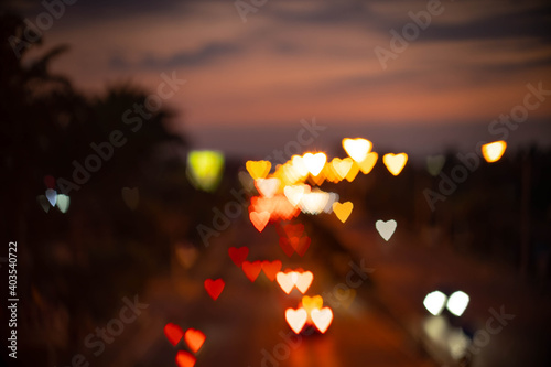 Defocused heart shape lights bokeh on traffic. 