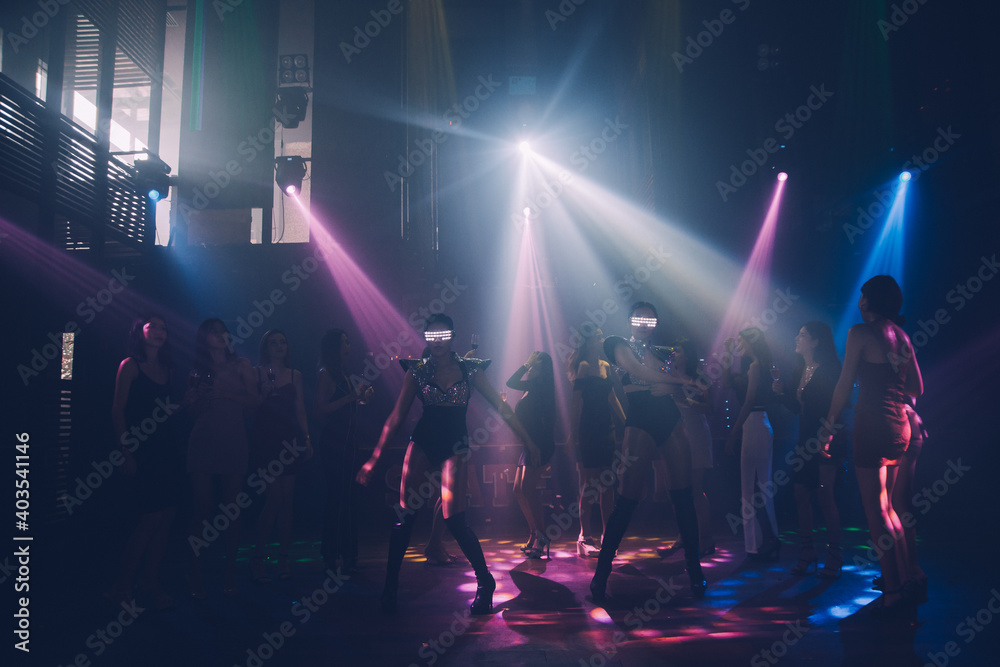 Group people women dancing in night party with DJ  EDM Music