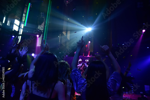 Group people women dancing in night party with DJ  EDM Music © Suriyo