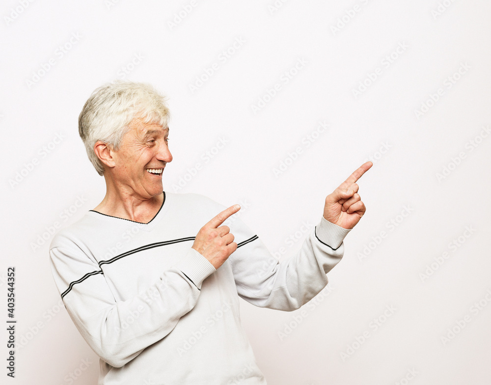 Lifestyle, emotion and old people concept. Happy senior man show something over white background Lifestyle, emotion and old people concept. Happy senior man show something over white background