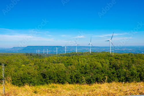 A large wind turbine was installed in the middle of the forest to generate electricity.