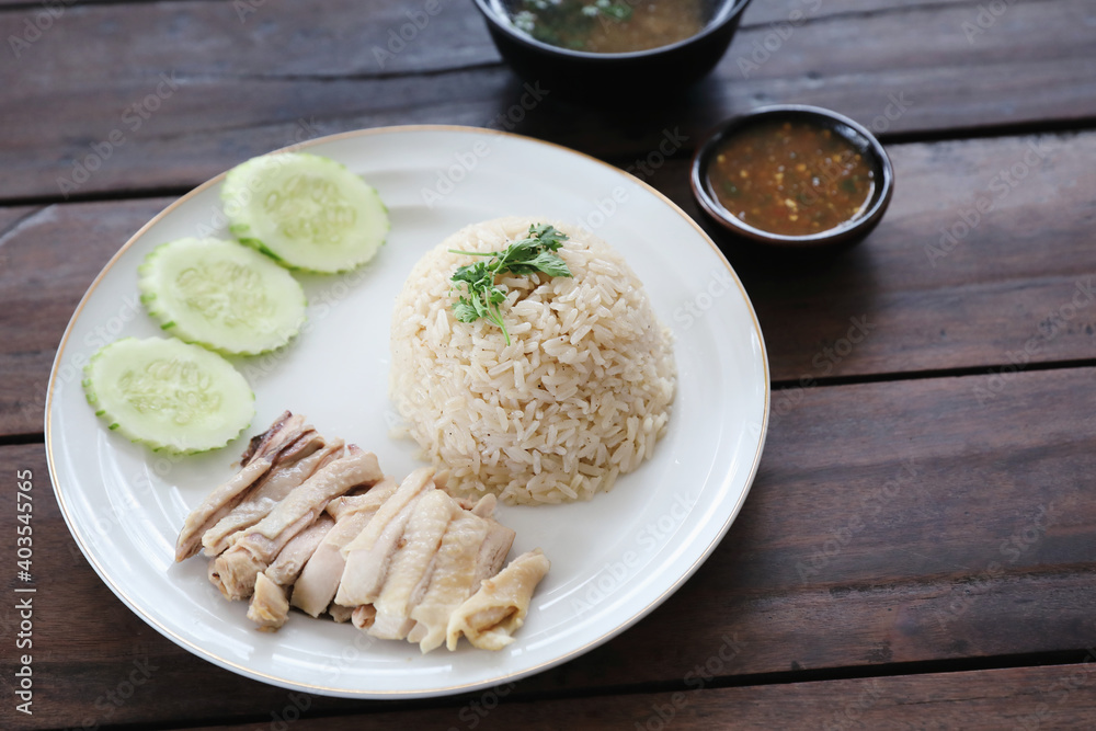 Thai food gourmet steamed chicken with rice khao mun kai in wood background Thai food gourmet steamed chicken with rice khao mun kai in wood background