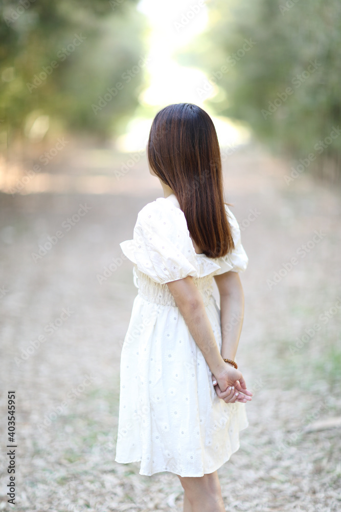 Beautiful young woman with white dress on garden background Beautiful young woman with white dress on garden background