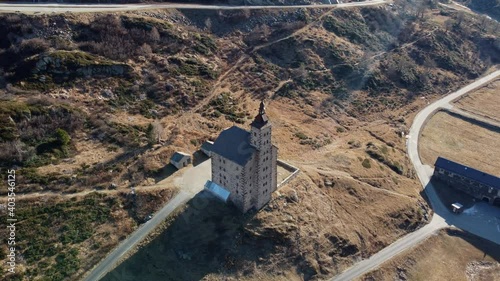 Historical landmark on the Simplon Pass in autumn. Old Spittel. Old castle in the mountains. Castle top, church tower, Stockalper, Aerial with mountain panorama. photo