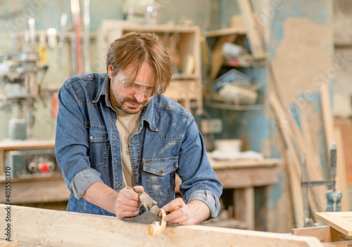 Carpenter planed wood in a workshop. Empty space for text