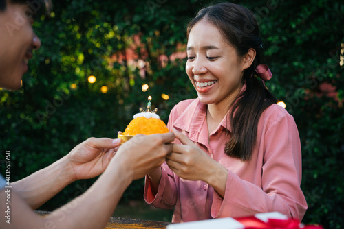 Asian girlfriend celebrate birthday party with golden thread dessert cake with boyfriend.